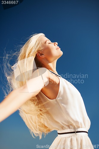 Image of beautiful woman enjoying summer outdoors