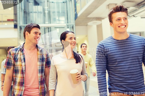 Image of group of smiling students with paper coffee cups