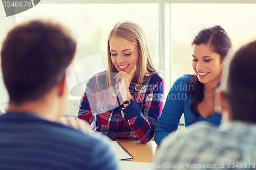 Image of group of smiling students with blueprint