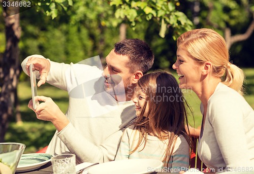 Image of happy family with tablet pc outdoors