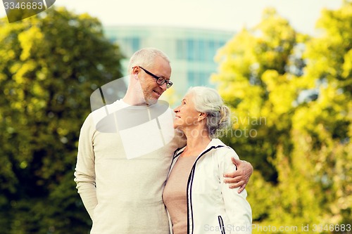 Image of senior couple hugging in city park