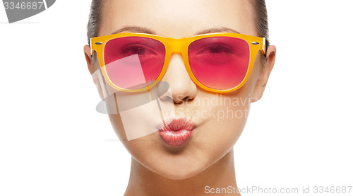 Image of girl in pink sunglasses blowing kiss