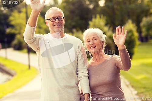Image of senior couple hugging in city park