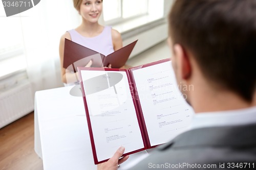 Image of close up of couple with menu at restaurant