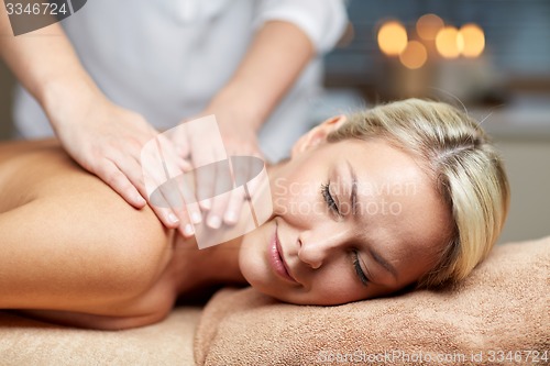 Image of close up of woman lying and having massage in spa