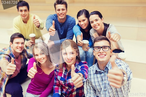 Image of group of smiling students with paper coffee cups