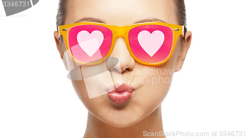 Image of girl in pink sunglasses blowing kiss