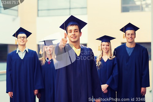 Image of group of smiling students in mortarboards