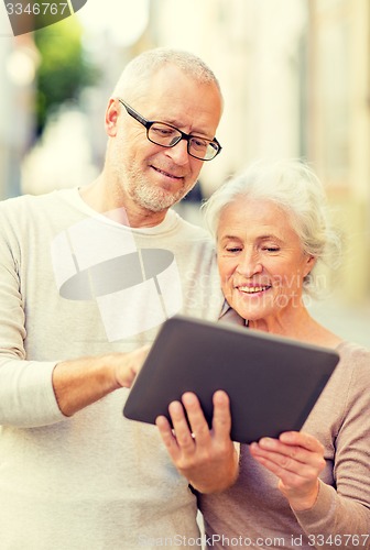 Image of senior couple photographing on city street