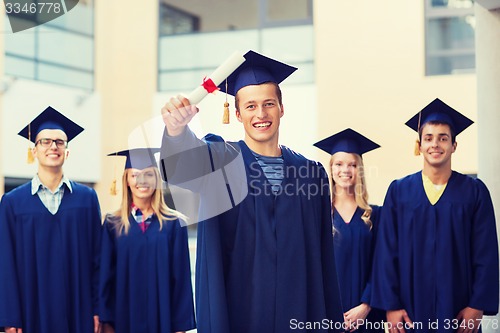 Image of group of smiling students in mortarboards