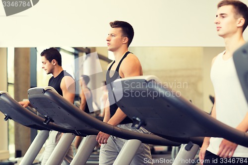 Image of group of men exercising on treadmill in gym