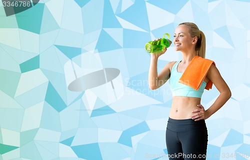 Image of woman with bottle of water and towel