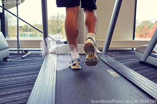 Image of close up of man legs walking on treadmill in gym