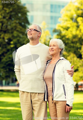 Image of senior couple hugging in city park