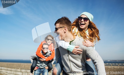 Image of happy teenage friends having fun outdoors