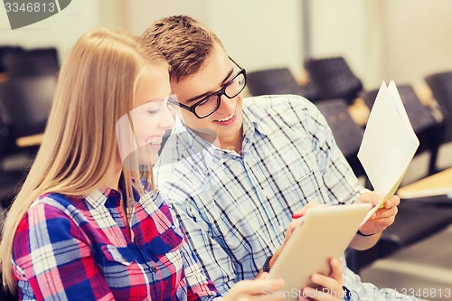 Image of group of smiling students with notebooks