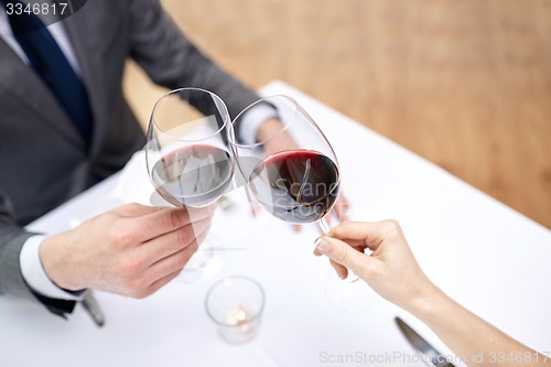 Image of young couple with glasses of wine at restaurant