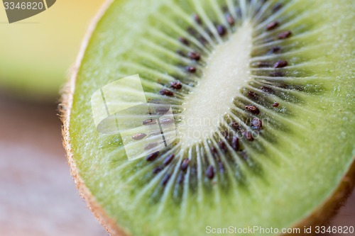 Image of close up of ripe kiwi slice on table
