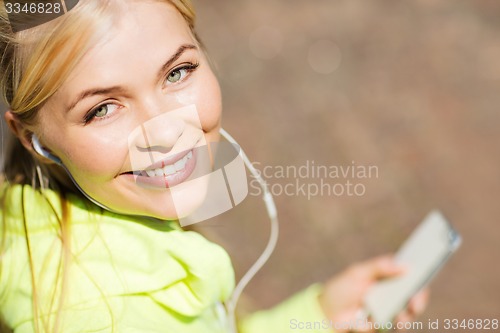Image of woman listening to music outdoors