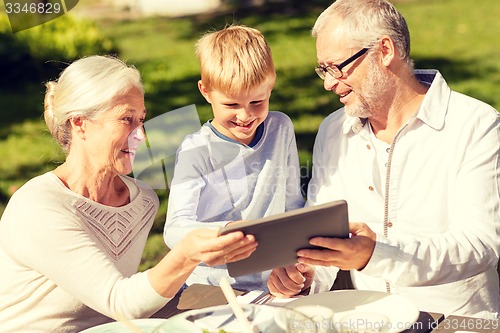 Image of happy family with tablet pc outdoors