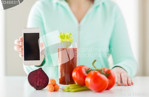 Image of close up of woman with smartphone and vegetables