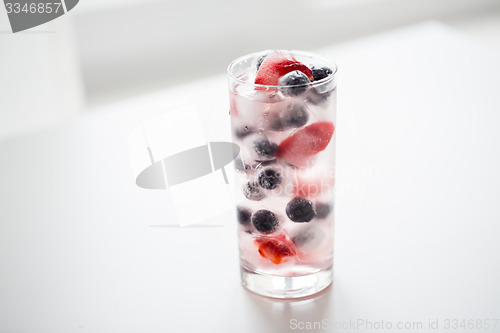 Image of close up of fruit water with ice cubes in glass