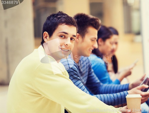 Image of group of students with tablet pc and coffee cup