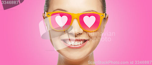 Image of smiling teenage girl in pink sunglasses