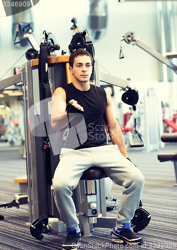 Image of man exercising on gym machine