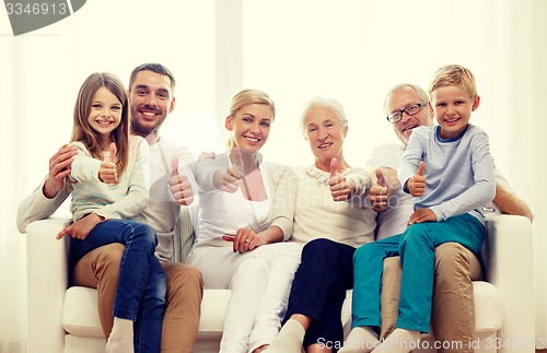 Image of happy family sitting on couch at home