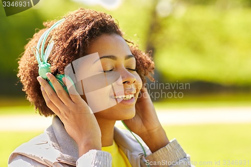 Image of african woman in headphones listening to music