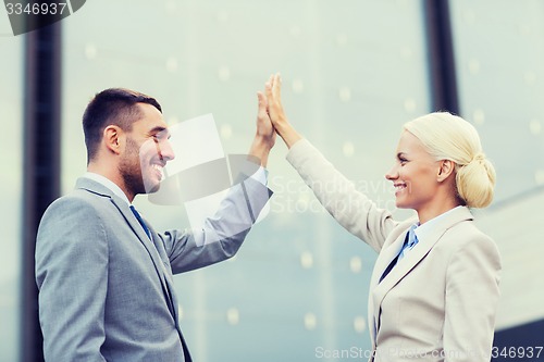 Image of smiling businessmen outdoors