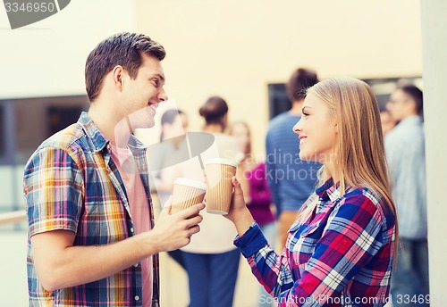 Image of group of smiling students with paper coffee cups