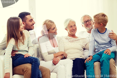 Image of happy family sitting on couch at home