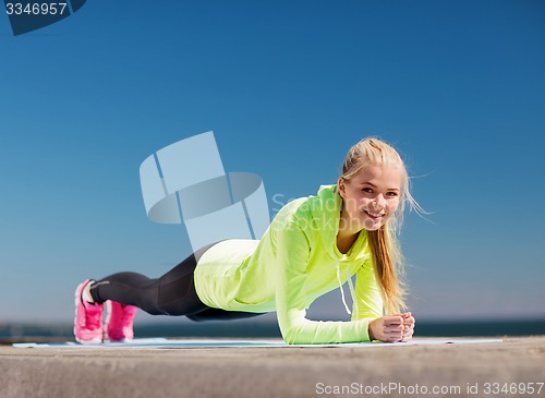 Image of woman doing sports outdoors