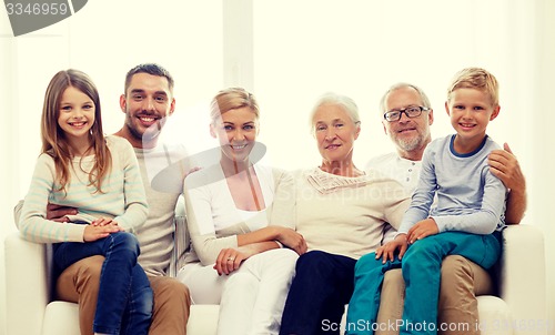 Image of happy family sitting on couch at home