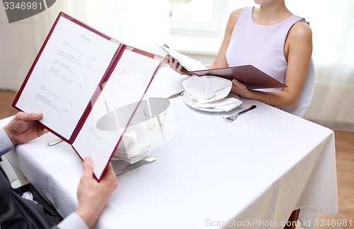 Image of close up of couple with menu at restaurant