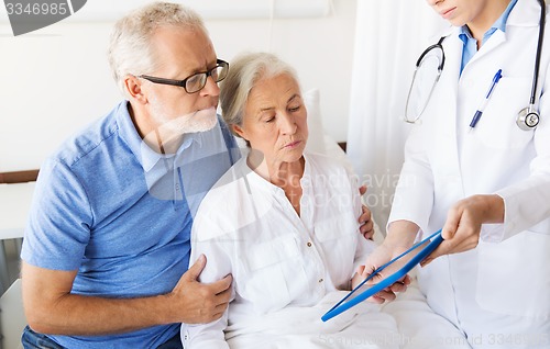 Image of senior woman and doctor with tablet pc at hospital