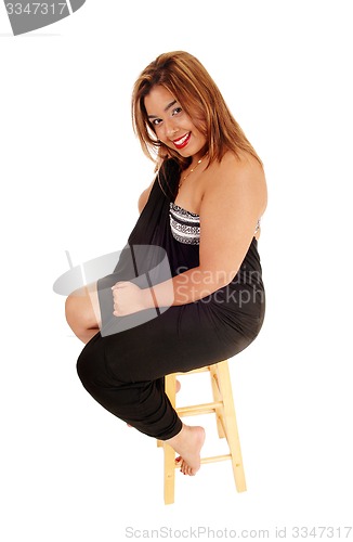 Image of Young Asian woman sitting on chair.