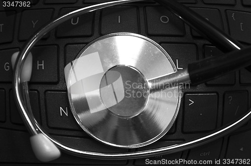 Image of Black stethoscope on the keyboard side