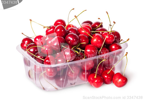 Image of Sweet cherries in plastic tray and three near top view