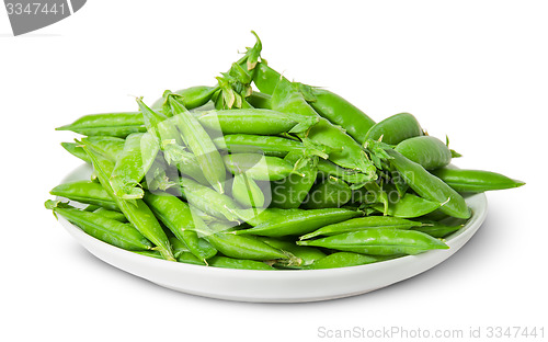 Image of Big pile of green peas in pods on white plate