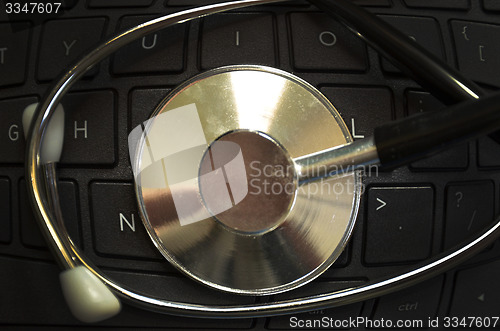 Image of Black stethoscope on the keyboard side