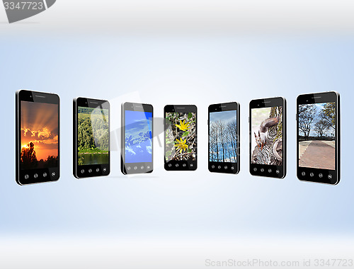 Image of Modern mobile phones with different images