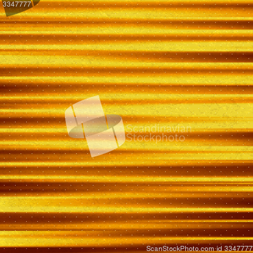 Image of Abstract gold background. Metal plate with reflected light. 