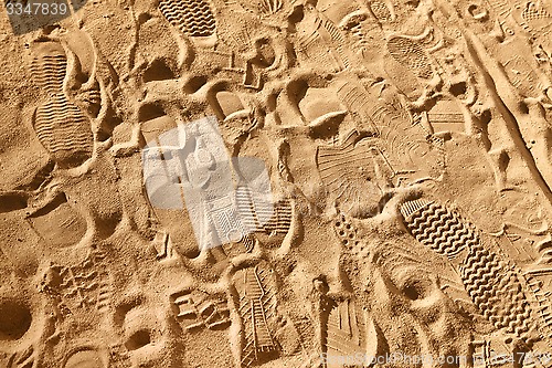 Image of footwear prints on sand