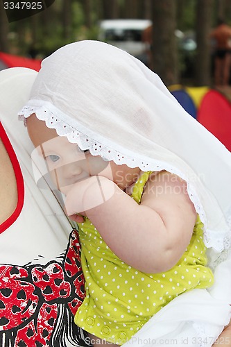 Image of little baby in white mantlet