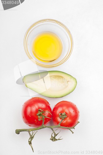 Image of View from above to the tomatoe, avocado, olive oil