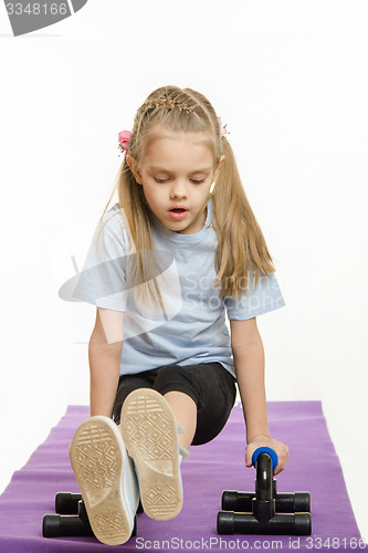 Image of Girl athlete is engaged with stops for push-ups