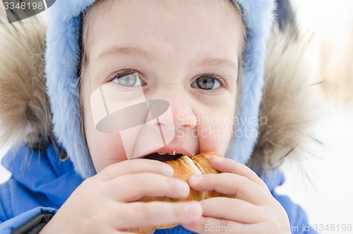 Image of Girl eating a roll